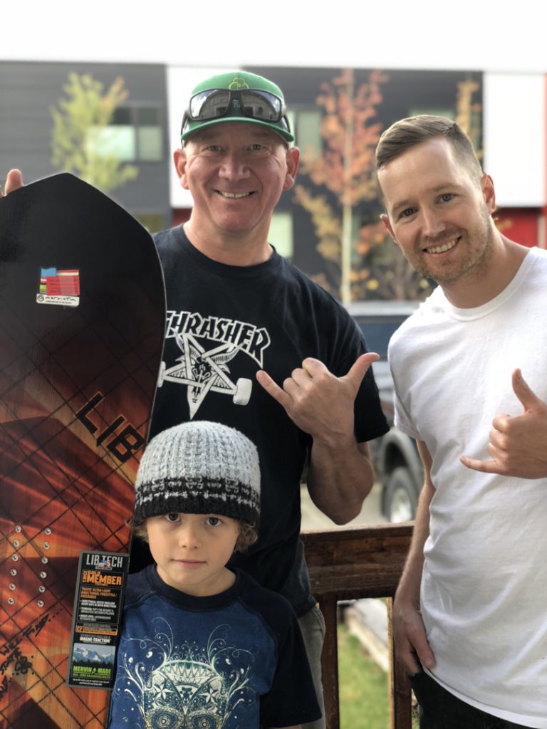 snowboarding. 18-19 JHSM. Adam Dowell with snowboard winner Jeff Musselman and Ryder. Jackson, Wyoming.